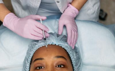 Close-up view of a botox injection being administered to a woman's forehead, representing modern cosmetology.